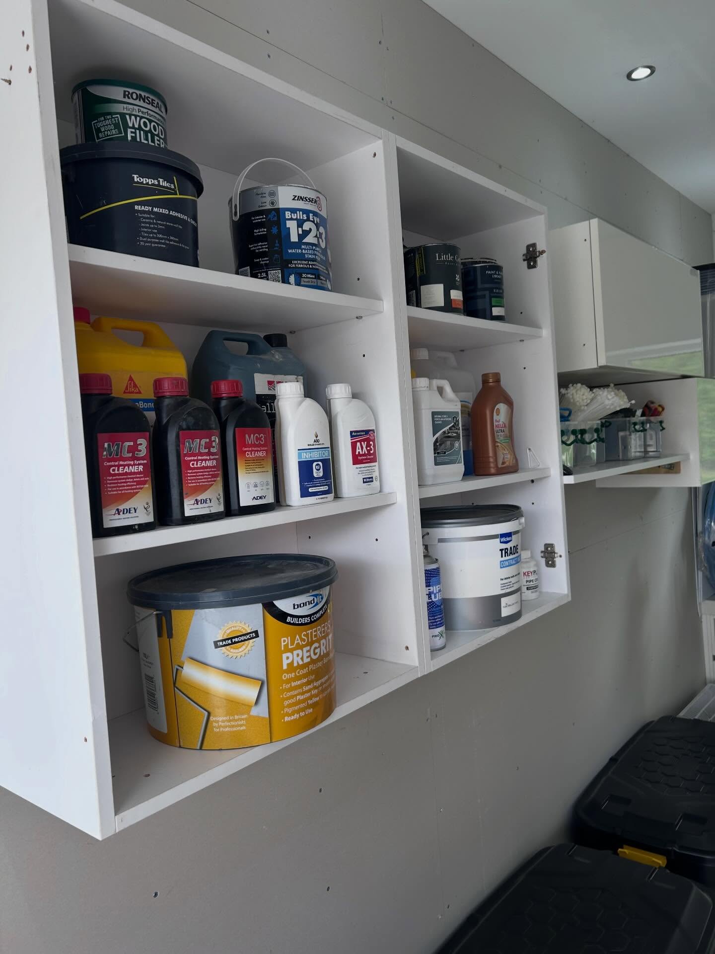 Wall-mounted shelving with trade supplies grouped into clear zones