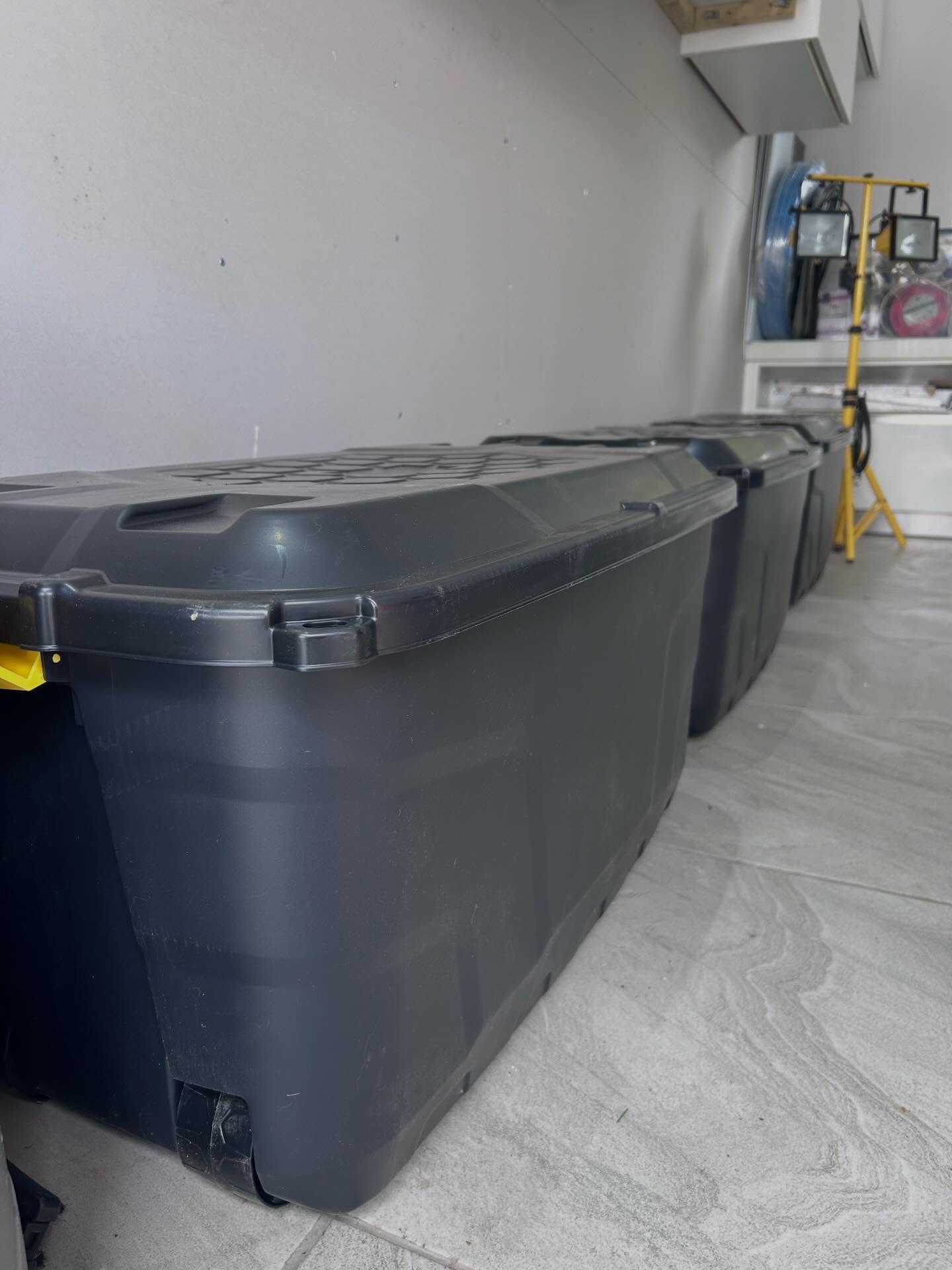 Heavy-duty floor storage trunks aligned along the garage wall