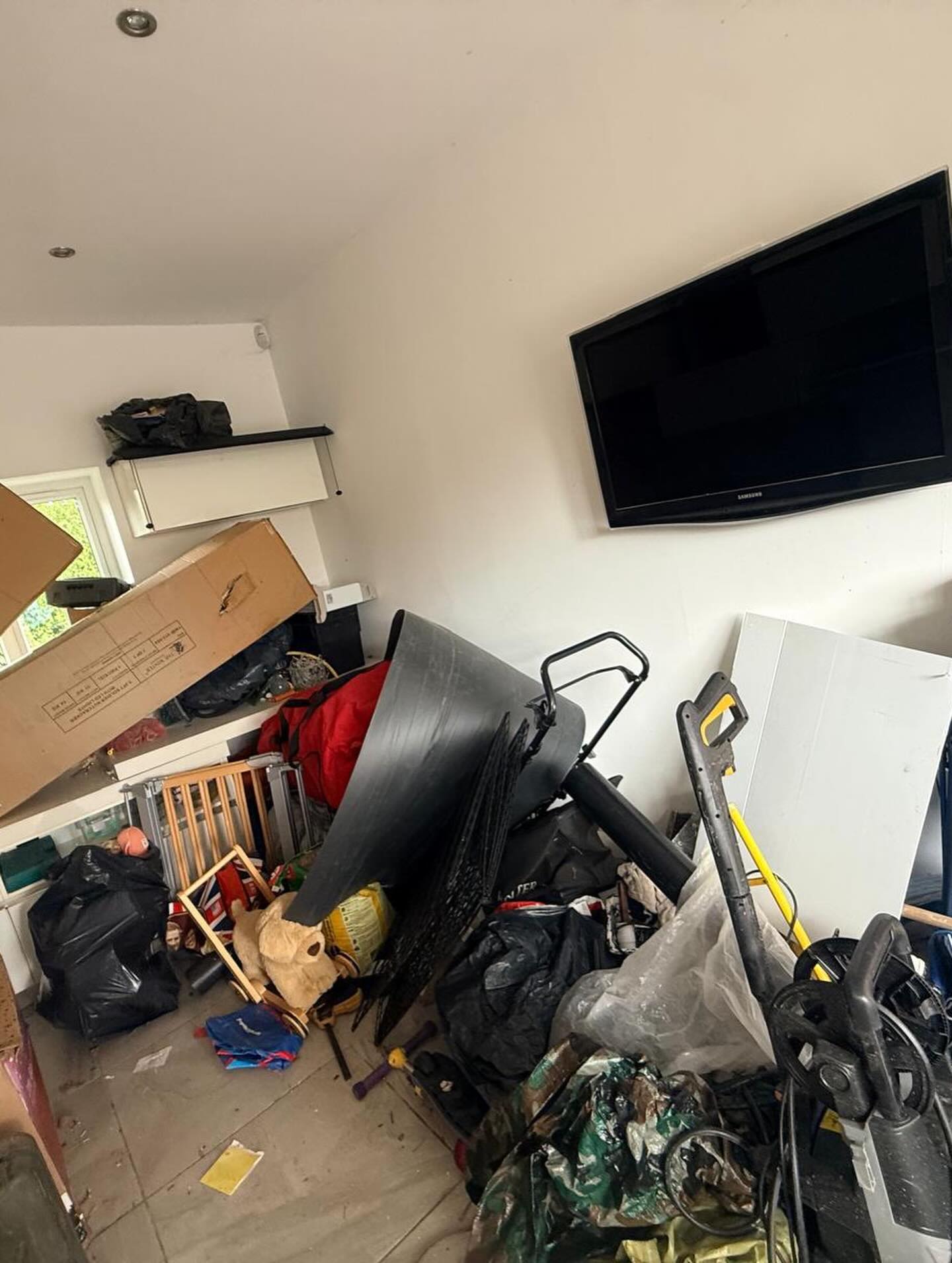 Garage interior before organisation with mixed tools and storage