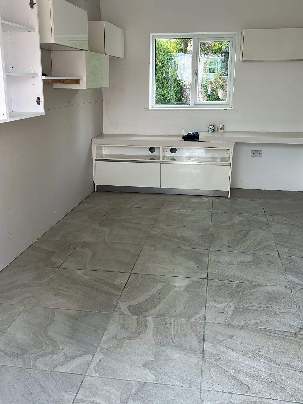 Cleared garage with cabinetry and workbench ready to organise